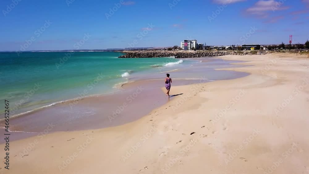 Woman Running on Beach in Australia Woman Running on Beach in Australia