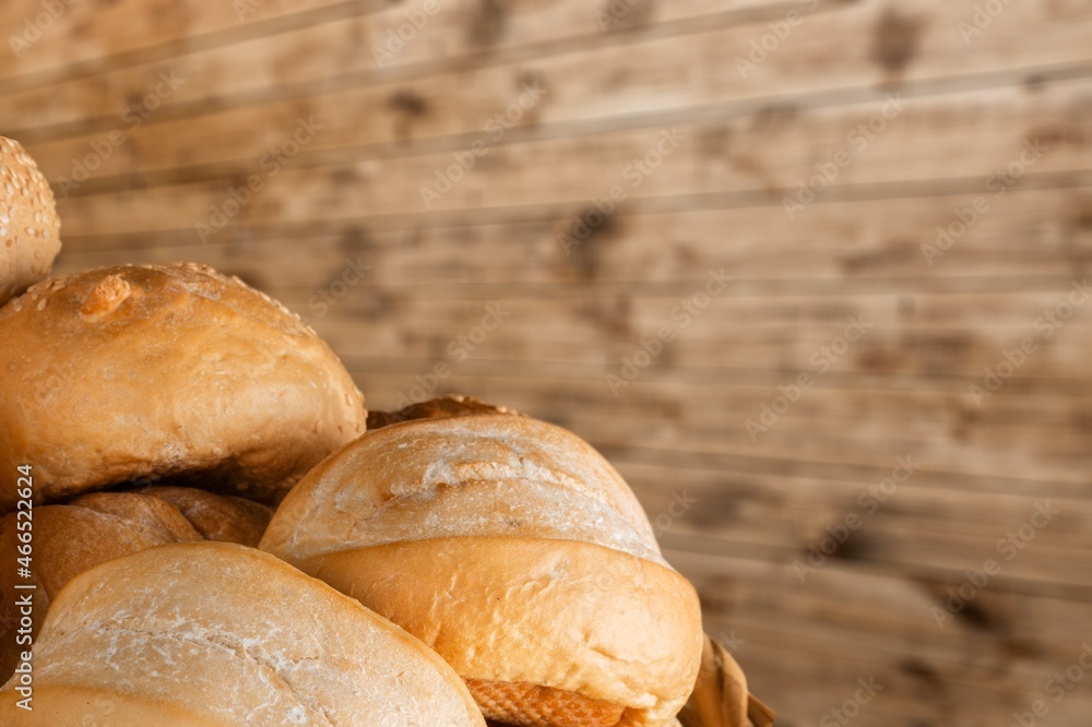 Fresh loaves of bread with wheat and gluten on a table