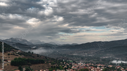 Morning fog over a Greek mountain village © andrey_iv