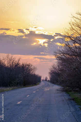 Colorful sunset over an old country road.