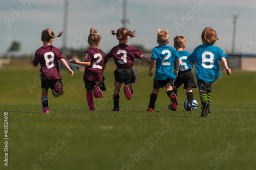 Young Children Kids Outside Playing Soccer Sport Running Together Team Numbers Boys Girls Fit Healthy Lifestyle 