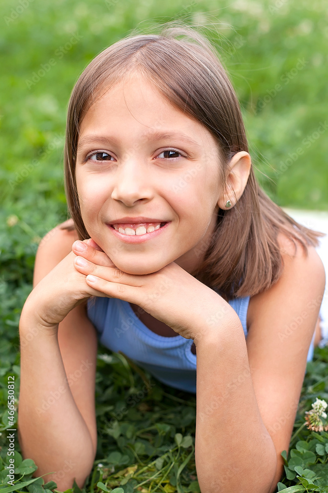 a cheerful girl of 8-10 years old plays on a green meadow on a warm summer day, walks in the fresh air, joy and happiness a cheerful girl of 8-10 years old plays on a green meadow on a warm summer day, walks in the fresh air, joy and happiness