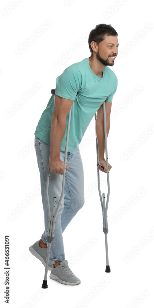 Full length portrait of man with crutches on white background Full length portrait of man with crutches on white background