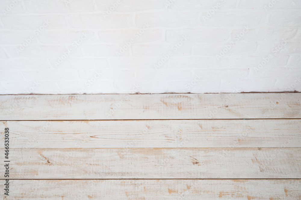 White brick wall and old wooden background