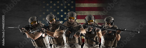 Quadro em tela Professional special forces soldiers, during a special operation against a dark concrete wall and US flag background