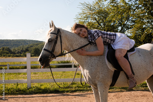 The young woman spends time with her favorite horse