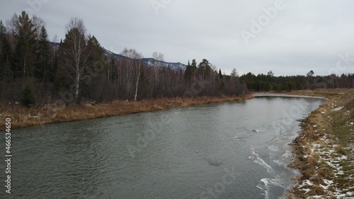 Late autumn. It's already cold and snowing. The mountain river begins to freeze and is covered with ice.