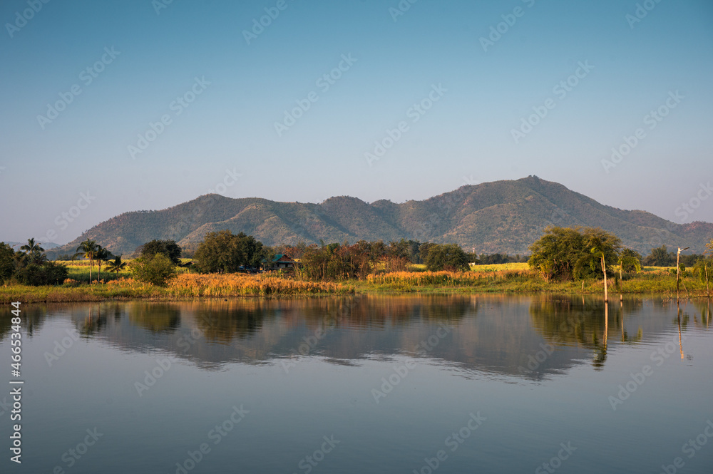 Mountain range reflected on Lam Thaphoen reservoir