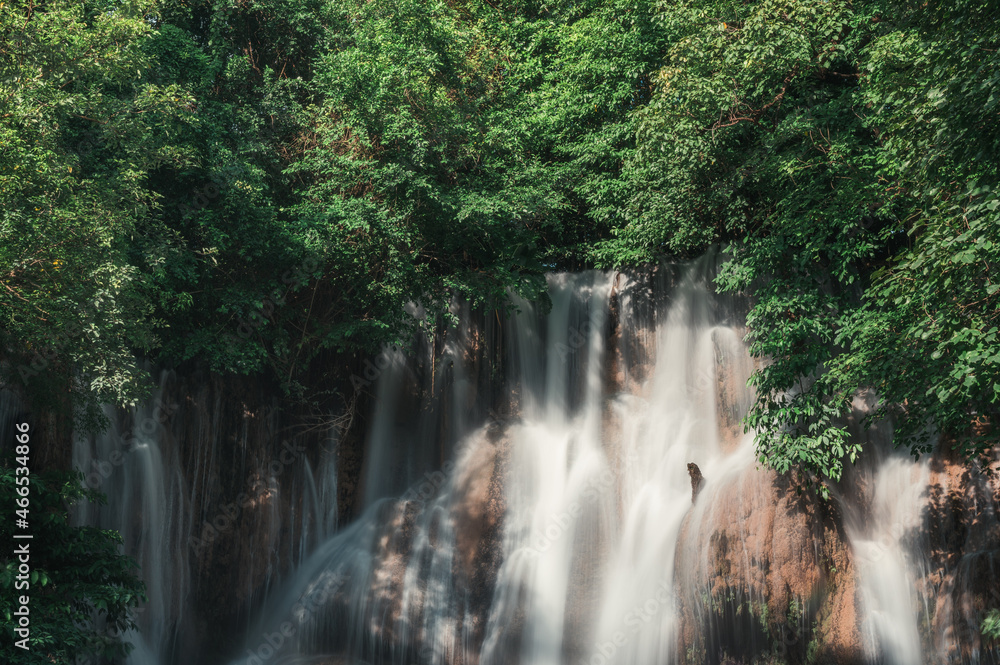 Obraz premium Sai Yok Noi waterfall flowing on limestone in tropical rainforest at national park