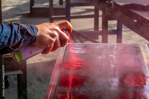 Fotografie Spraying liquid penetrant to detect defects in welds