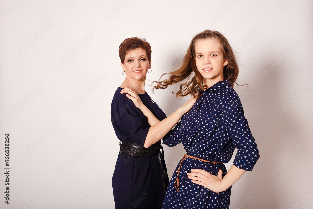 mother and daughter teenager on white background mother and daughter teenager on white background