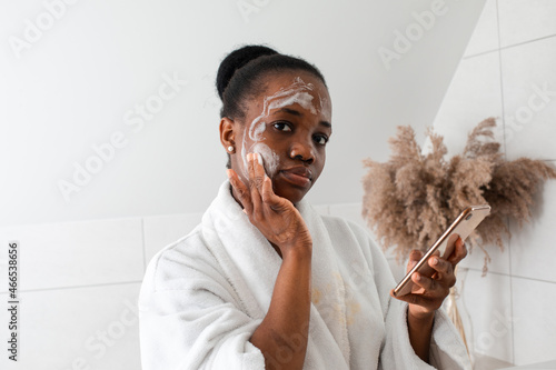 Woman learing to do skincare procedures at home photo