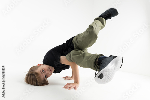 Fotografie Isolated young cute Russian teenage boy in black t-shirt hip hop break dancer da