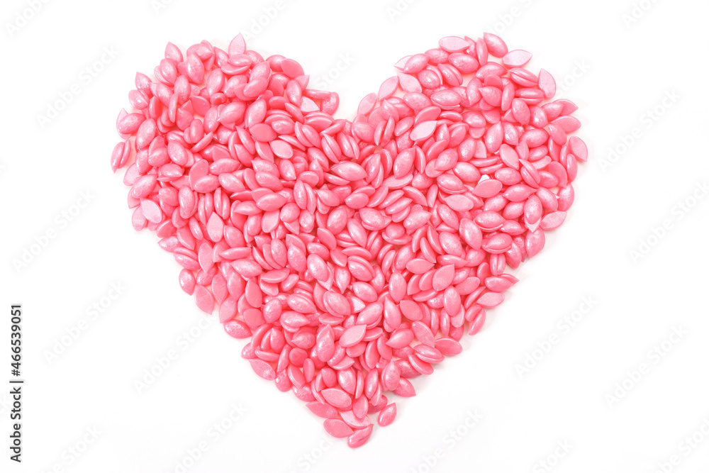 pink wax for depilation in granules, in the shape of a heart