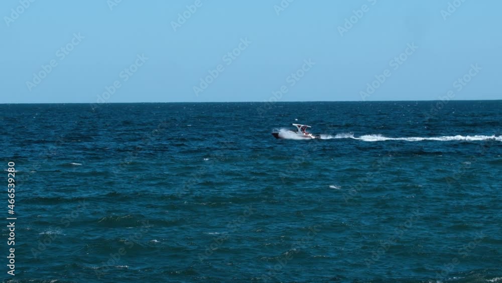 The boat goes through the blue sea water The boat goes through the blue sea water