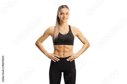 Yоung female in crop top and leggings smiling