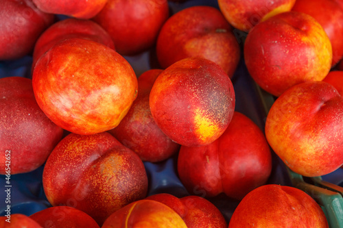 Ripe nectarines in a plastic container.