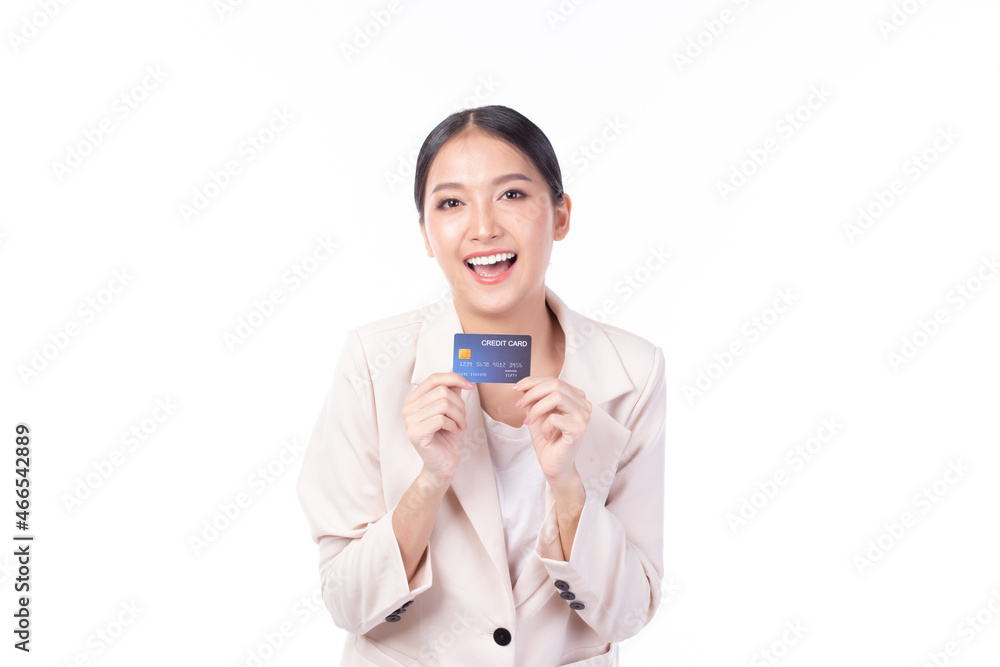 Portrait of a happy young asian woman wearing suit holding bank card, credit card isolated on white background. Business online shopping concept. Portrait of a happy young asian woman wearing suit holding bank card, credit card isolated on white background. Business online shopping concept.