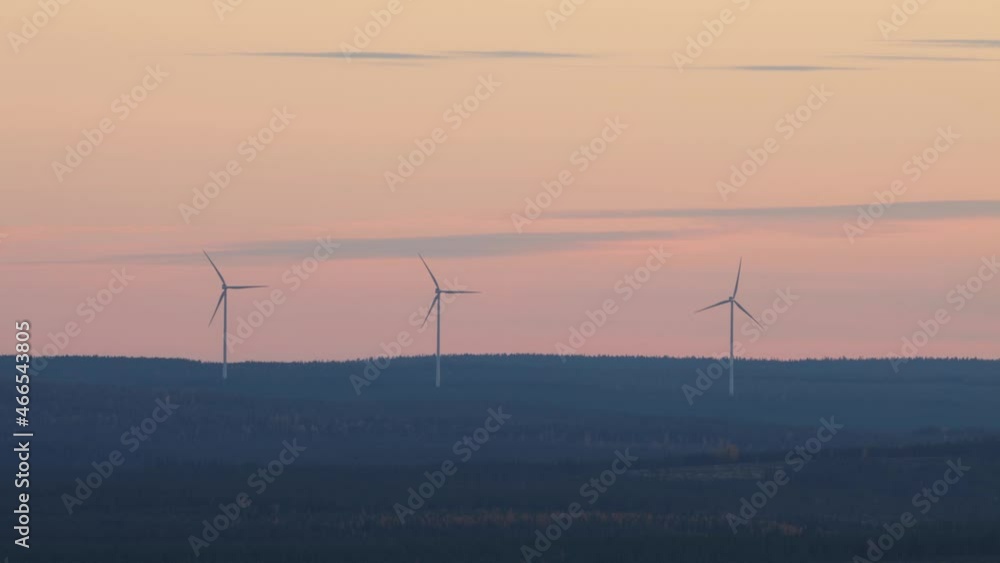 Three wind turbines working in Northern Finland during a darkening evening. Three wind turbines working in Northern Finland during a darkening evening.