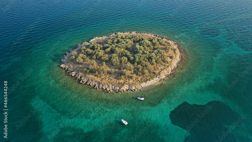 Fototapeta premium Aerial drone photo of tropical exotic paradise bay with deep turquoise sea forming a blue lagoon visited by luxury yachts and sail boats