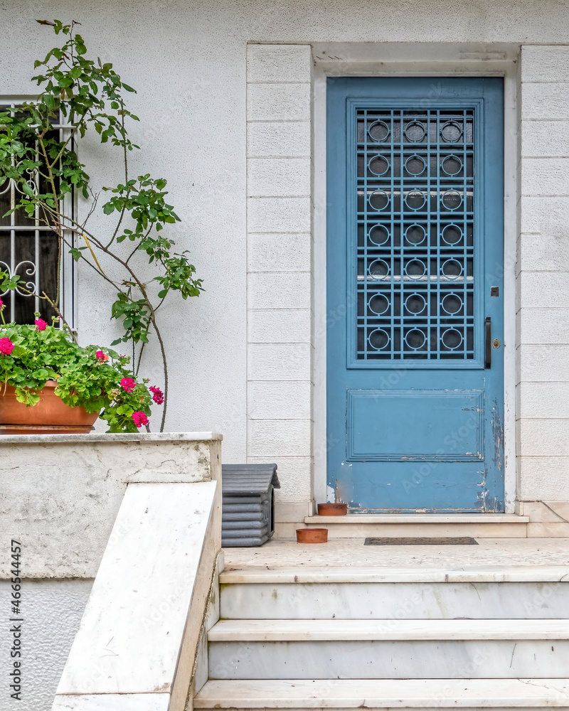 traditional house entrance light blue door and flowerpot, Athens Greece traditional house entrance light blue door and flowerpot, Athens Greece