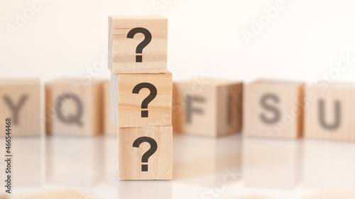 wooden blocks with lhe three question marks, concept. photo