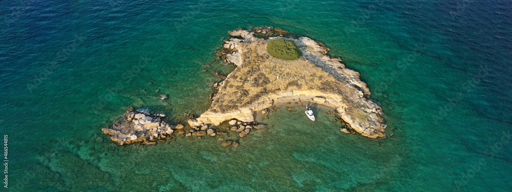 Aerial drone top down photo of small tropical exotic island covered in  limestone with emerald sea