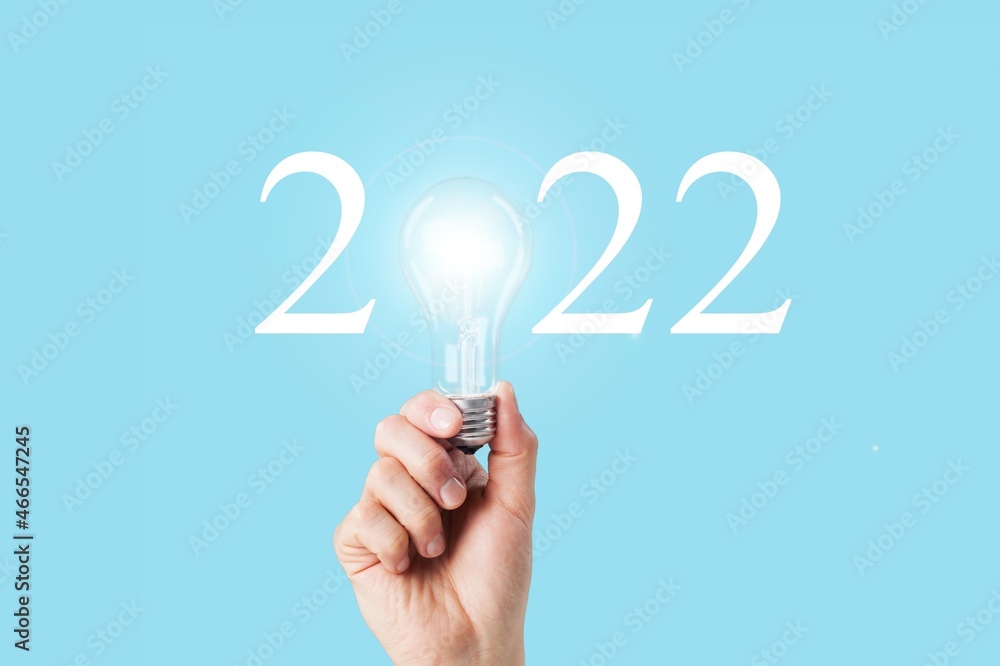 Idea and creative in 2022 text, lighting bulb with new year number on blue background Idea and creative in 2022 text, lighting bulb with new year number on blue background