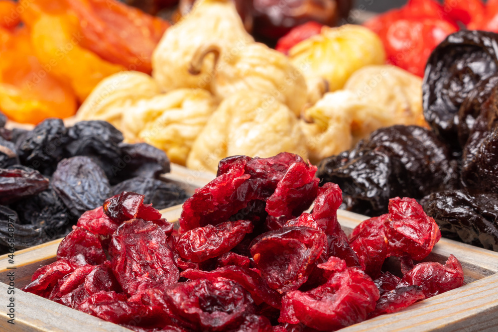dried cranberries in a wooden box close-up and other dried fruits dried cranberries in a wooden box close-up and other dried fruits