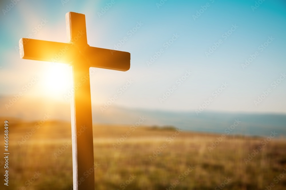 Easter concept. Cross of Jesus Christ on dramatic sunrise sky panorama with clouds.