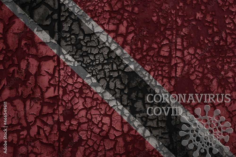 flag of trinidad and tobago on a old metal rusty cracked wall with text coronavirus, covid, and virus picture. flag of trinidad and tobago on a old metal rusty cracked wall with text coronavirus, covid, and virus picture.