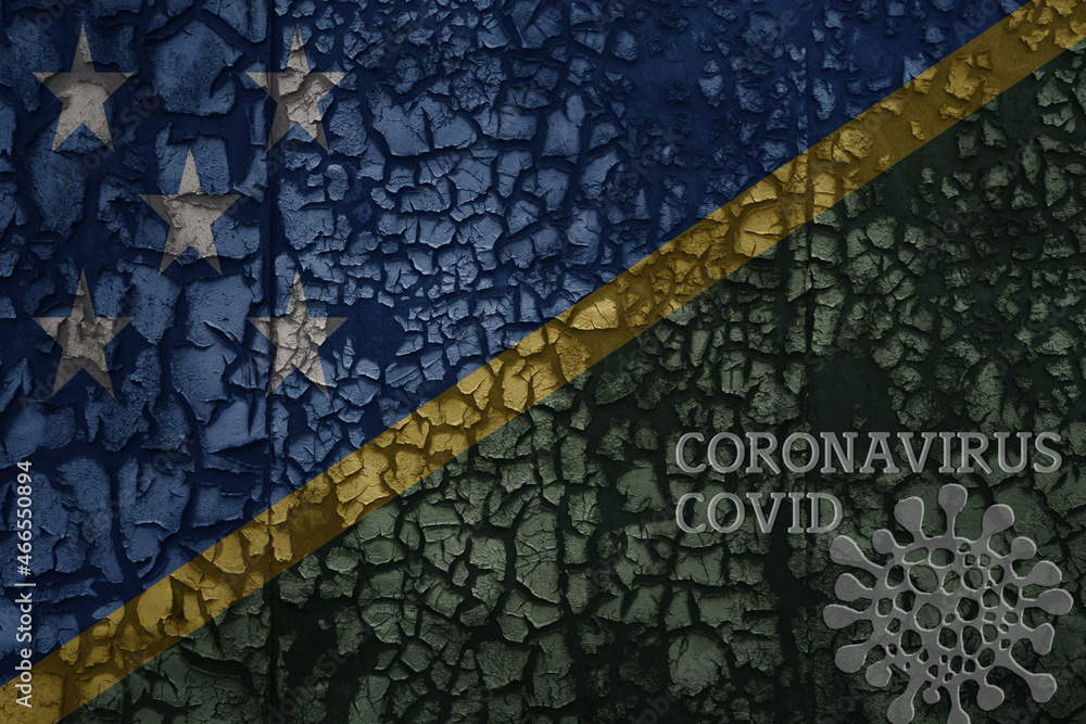 flag of Solomon Islands on a old metal rusty cracked wall with text coronavirus, covid, and virus picture.