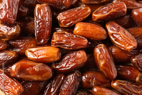 Tasty sweet dried dates as background, top view photo