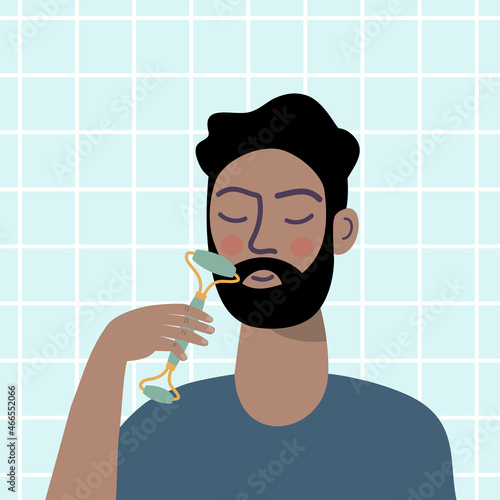 Man giving himself a facial massage with jade roller.