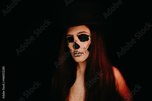 A girl with skull make up. Halloween happy party.