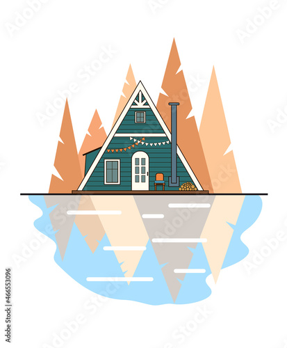Green a-frame cabin on the lake shore. Triangular autumn trees on the background. Cozy forest landscape.