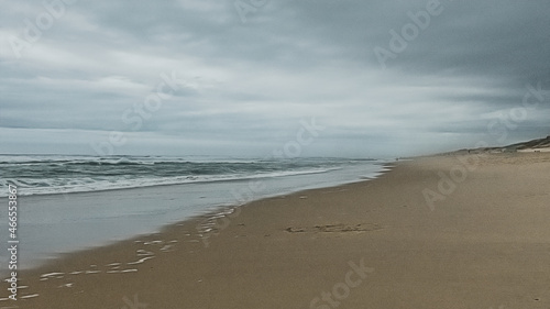 Cloudy beach landscape with ocean waves in France