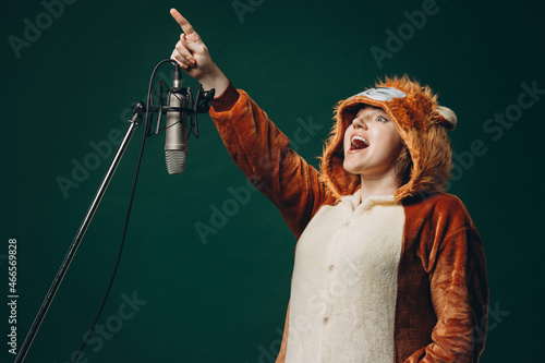 Woman prepares herself and a material before voice recording. Soundproof room for professional recording vocal. Voice artist works with material before dubbing or voice over process