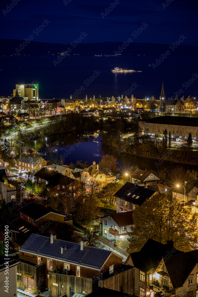Fototapeta premium Munkholmen by night with Trondheim and Nidelva in the frame