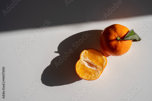 Gennevilliers, France - 10 17 2021: still life. Studio shot of orange clementine in natural sun light photo