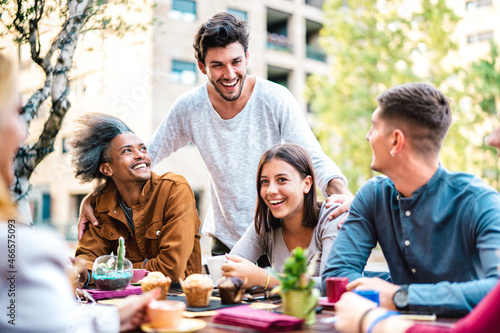 Multicultural friends drinking cappuccino at coffee bar restaurant - Young people having fun together at outdoor cafeteria garden - Life style concept with happy men and women at cafe on bright filter