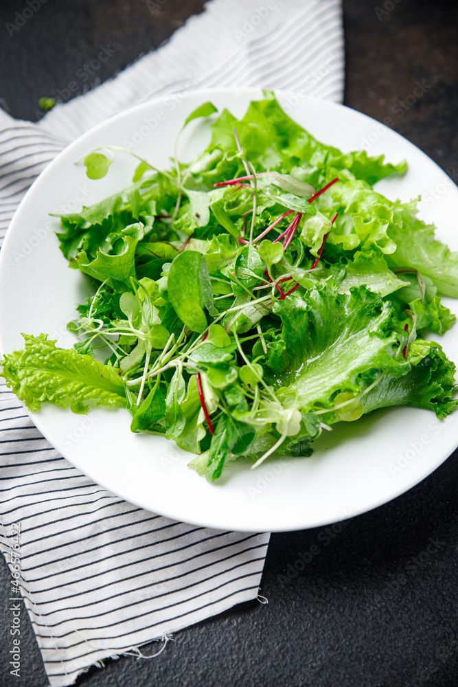 green salad leaves mix fresh herbs petals vitamin fresh meal snack on the table copy space food background rustic green salad leaves mix fresh herbs petals vitamin fresh meal snack on the table copy space food background rustic