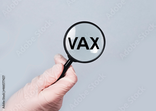 Vax word. Medical vaccination concept through magnifier