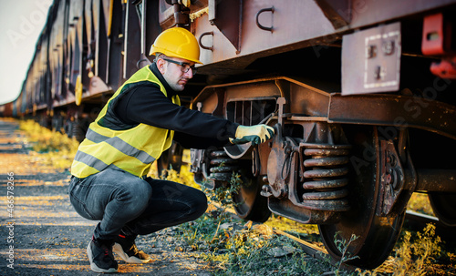 Safety first. Technician controls correctness of the freight car. Transportation concept