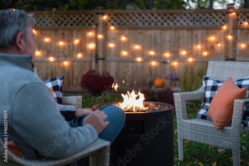 Fotografija Man relaxing in the backyard by a fire
