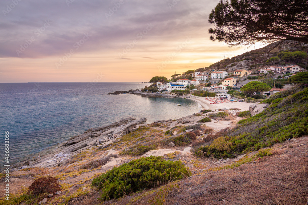 View at sunset over sandy beach of little village Seccheto at end of season at Island of Elba, Province of Livorno Italy View at sunset over sandy beach of little village Seccheto at end of season at Island of Elba, Province of Livorno Italy