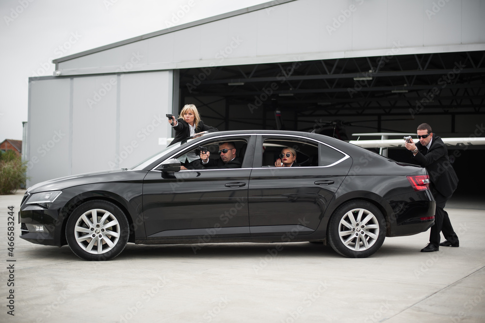 Security team of bodyguards protect celebrity vip in car limousine Security team of bodyguards protect celebrity vip in car limousine