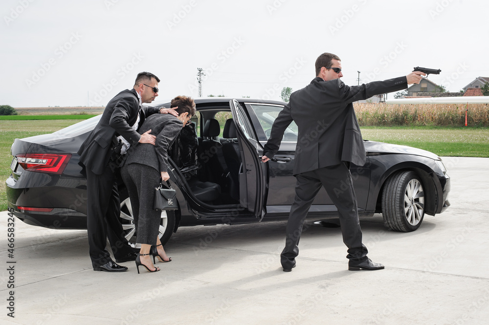 Foto Stock Security team of bodyguards protect celebrity vip in car  limousine | Adobe Stock