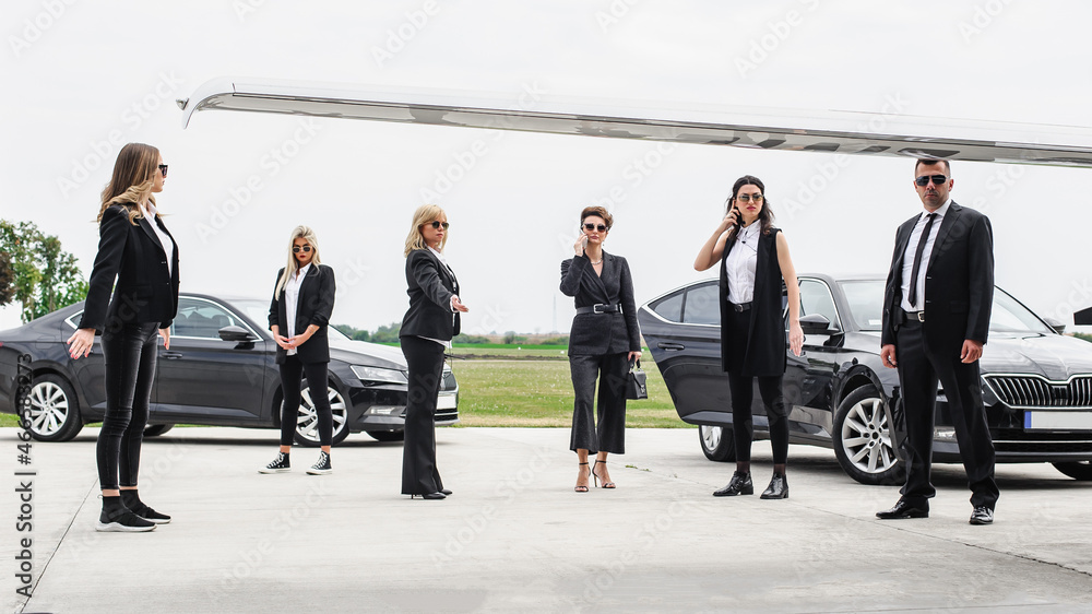 Female male security bodyguards team protect VIP celebrity public person Female male security bodyguards team protect VIP celebrity public person
