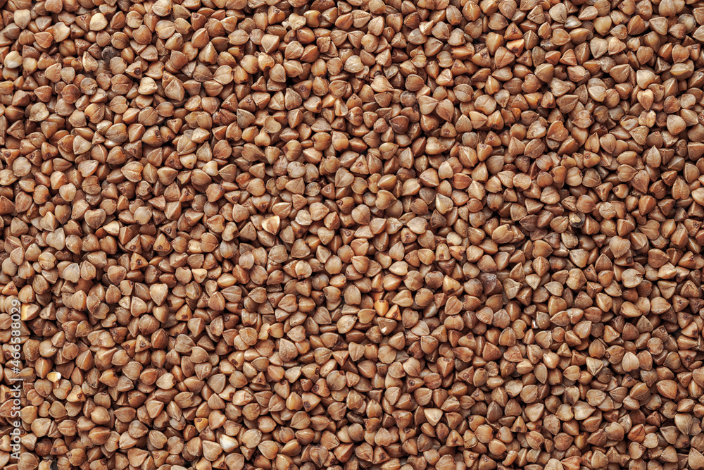 Buckwheat, not boiled, raw, kernel of grain, background, close-up Buckwheat, not boiled, raw, kernel of grain, background, close-up
